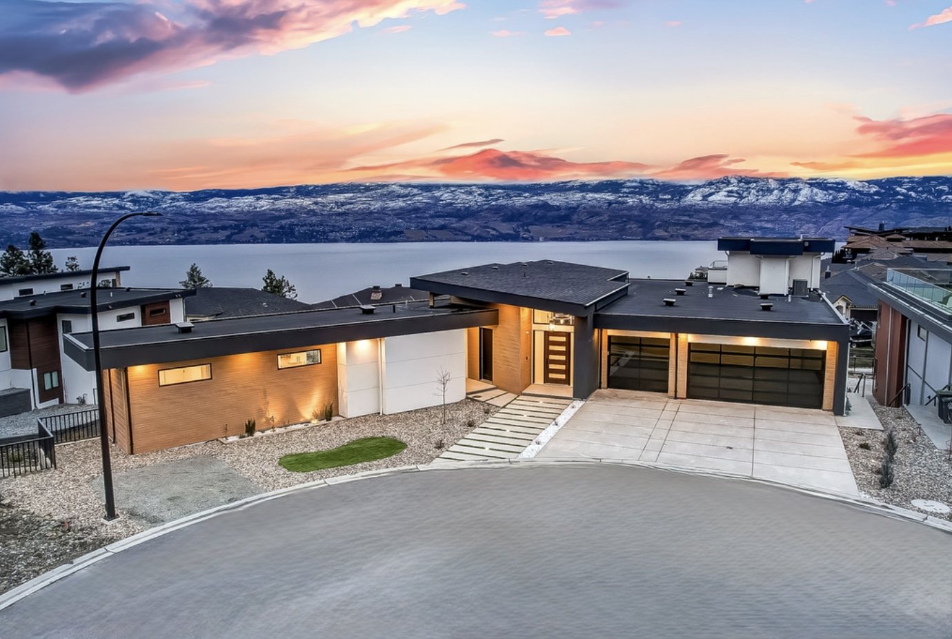 Contemporary Malbec Place home overlooking the Okanagan landscape at sunset